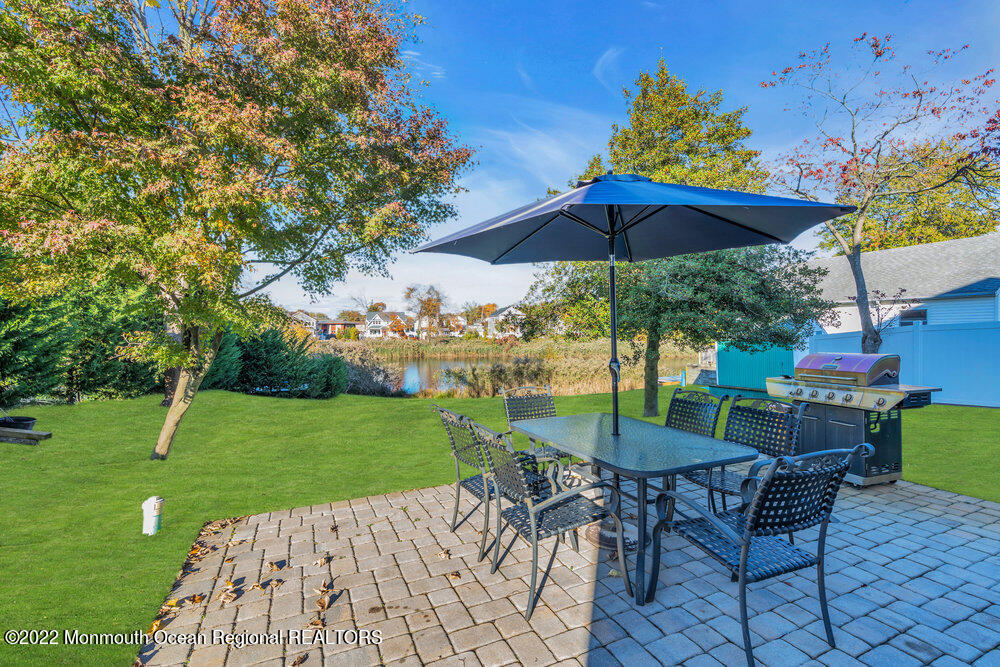 612 Lake Avenue Spring Lake Heights, NJ 07762 - Photo 18 of 22 a view of a patio with a table chairs under an umbrella
