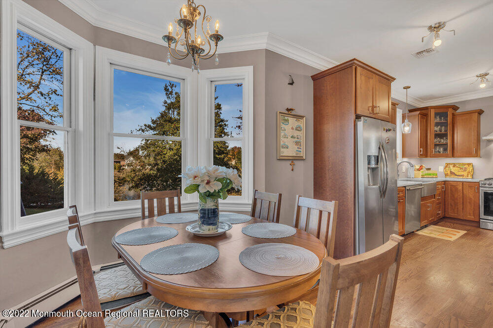 612 Lake Avenue Spring Lake Heights, NJ 07762 - Photo 5 of 22 a dining room with furniture a livingroom and chandelier