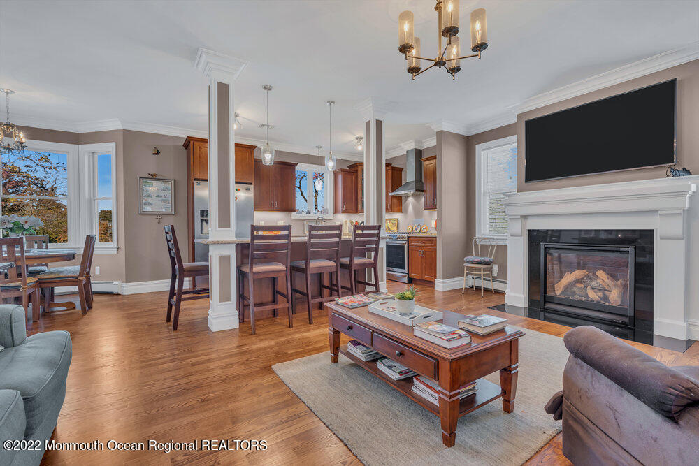 612 Lake Avenue Spring Lake Heights, NJ 07762 - Photo 6 of 22 a living room with furniture a fireplace and a flat screen tv