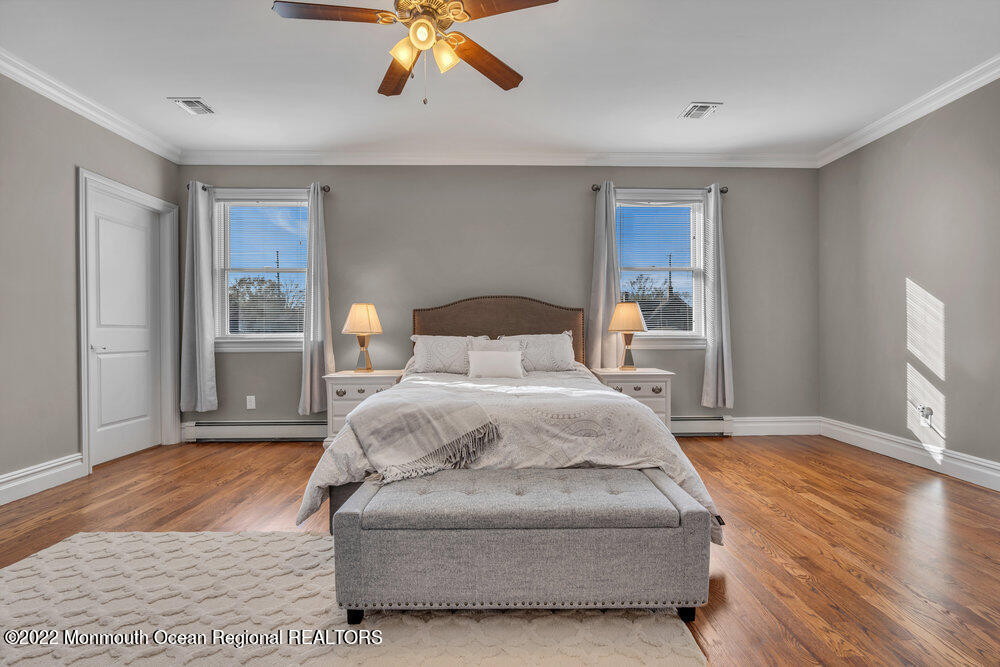 612 Lake Avenue Spring Lake Heights, NJ 07762 - Photo 10 of 22 a bedroom with a bed and wooden floor