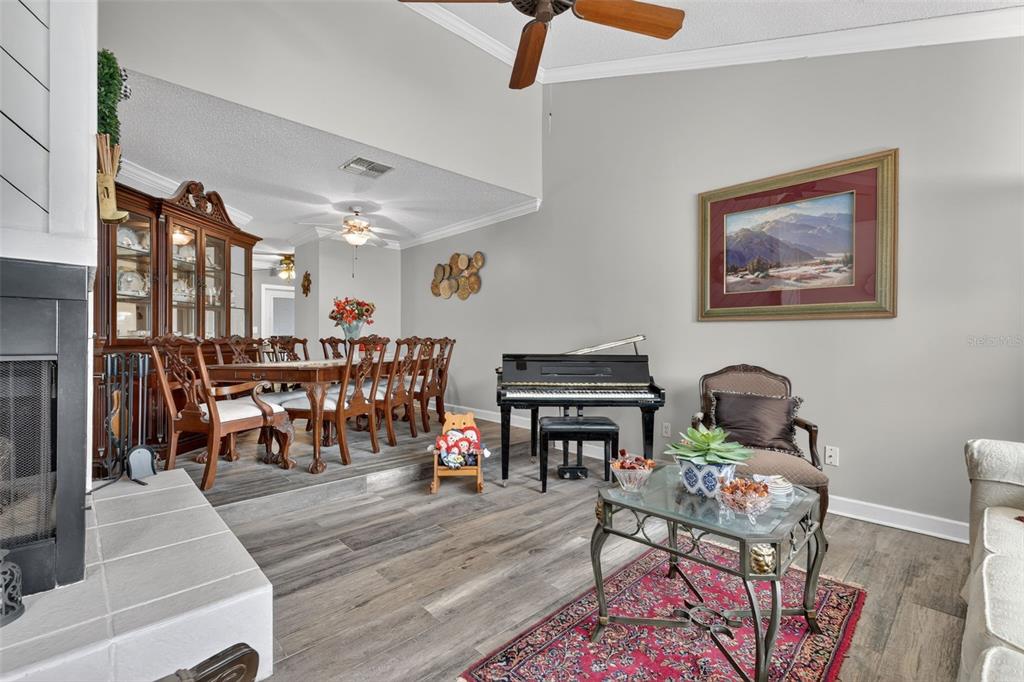 575 Tiberon Cove Road Longwood, FL 32750 - Photo 8 of 56 a living room with furniture and a fireplace