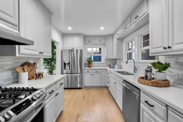 a kitchen with granite countertop a sink and cabinets