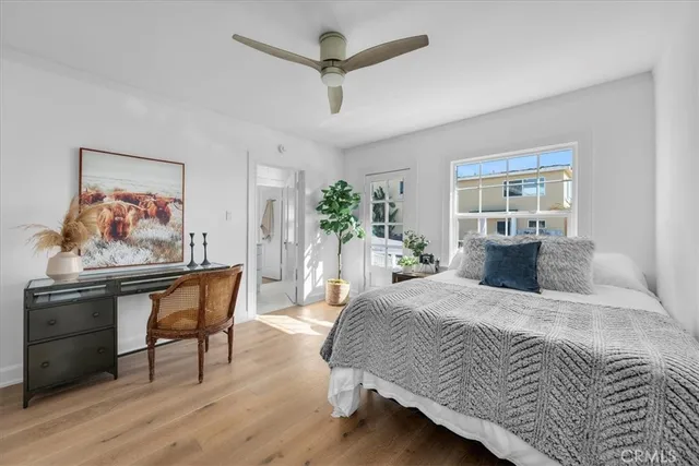 a bedroom with a bed a couch and a potted plant