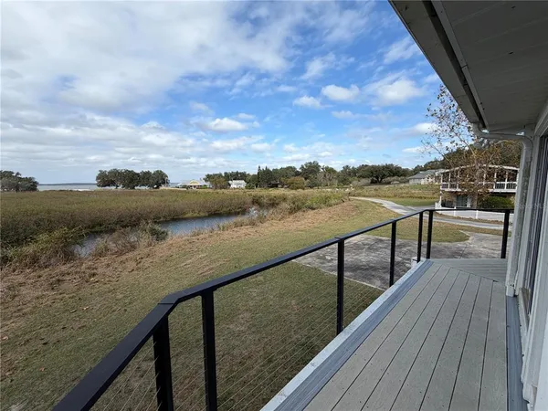 a view of a balcony with chair and wooden floor