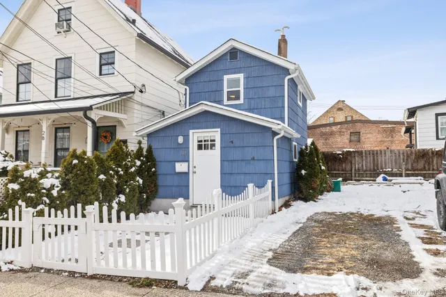 a view of a house with wooden fence