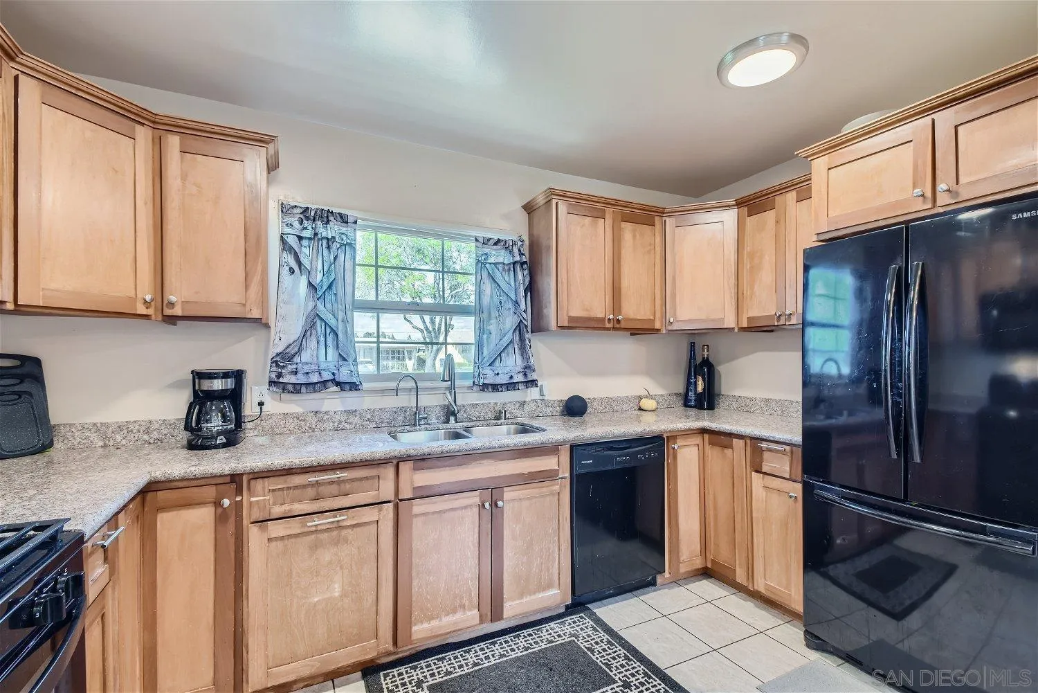 5259 Laurel Street San Diego, CA 92105 - Photo 12 of 32 a kitchen with stainless steel appliances granite countertop a sink stove and refrigerator