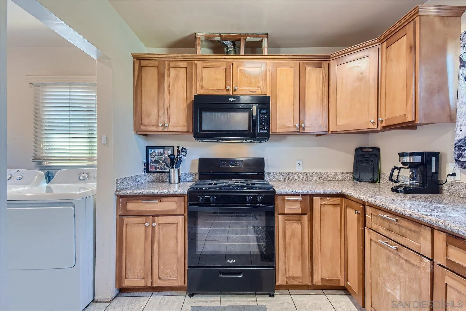 5259 Laurel Street San Diego, CA 92105 - Photo 14 of 32 a kitchen with granite countertop a stove a sink and a microwave