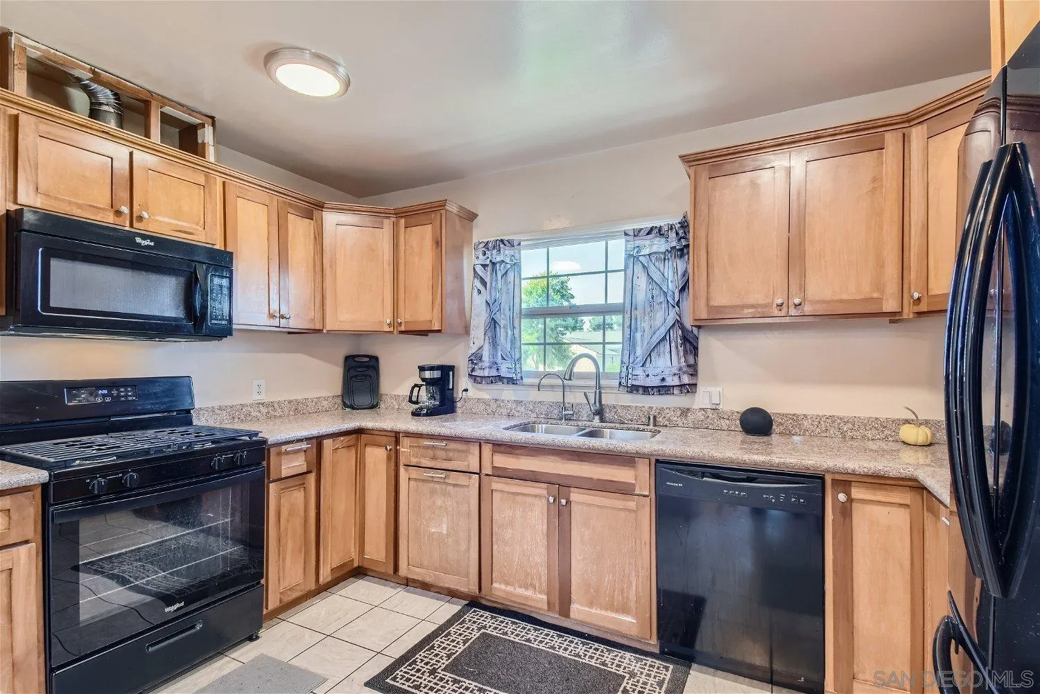 5259 Laurel Street San Diego, CA 92105 - Photo 15 of 32 a kitchen with a sink stove top oven and cabinets
