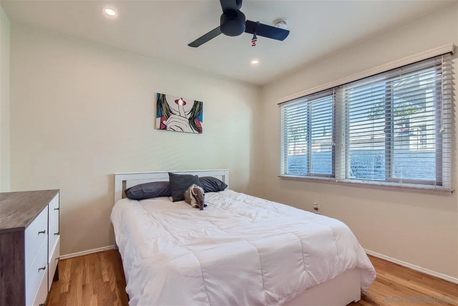 5259 Laurel Street San Diego, CA 92105 - Photo 16 of 32 a bedroom with a bed and a window