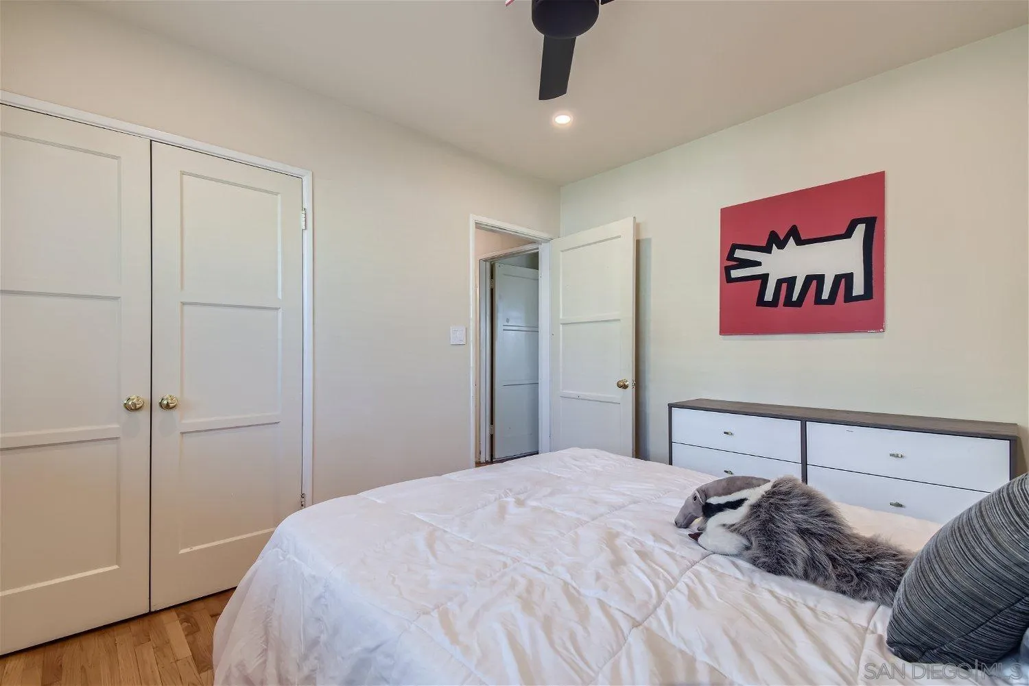 5259 Laurel Street San Diego, CA 92105 - Photo 17 of 32 a bedroom with a bed and a chandelier