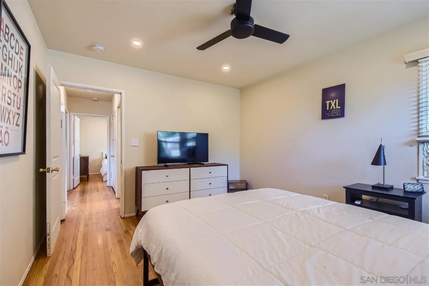 5259 Laurel Street San Diego, CA 92105 - Photo 18 of 32 a bedroom with a bed and a flat screen tv