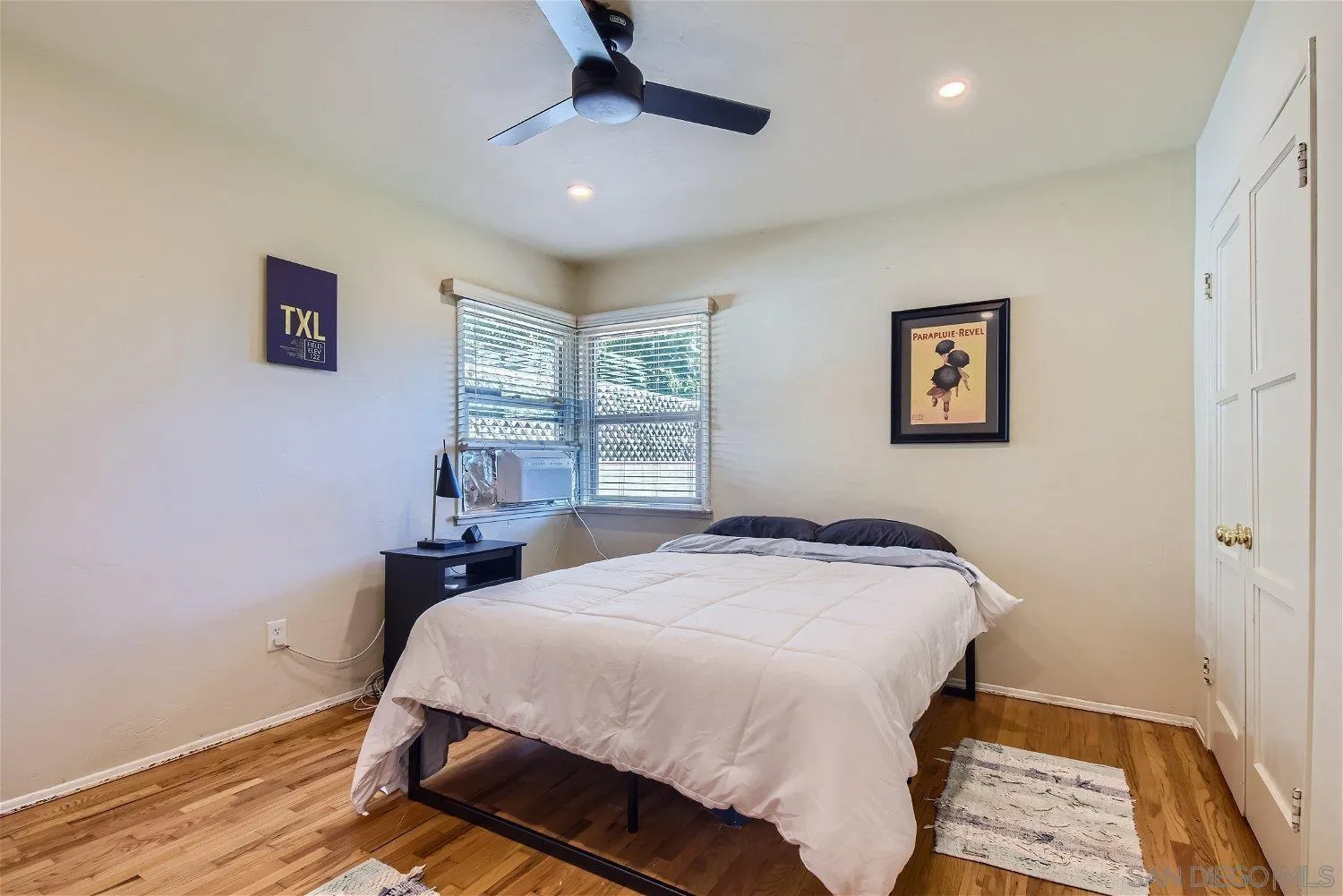 5259 Laurel Street San Diego, CA 92105 - Photo 20 of 32 a bedroom with a bed and a window