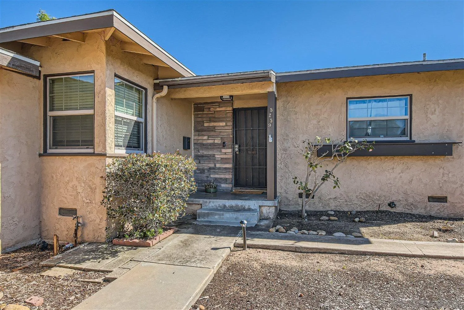 5259 Laurel Street San Diego, CA 92105 - Photo 2 of 32 a front view of a house with garden