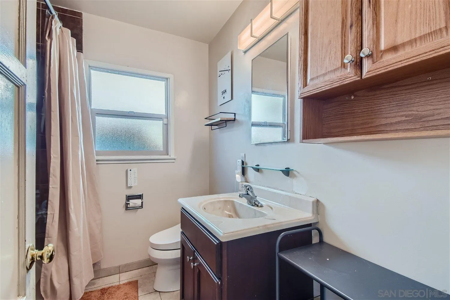 5259 Laurel Street San Diego, CA 92105 - Photo 22 of 32 a bathroom with a sink a toilet and a mirror