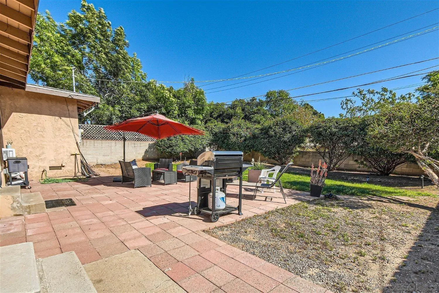 5259 Laurel Street San Diego, CA 92105 - Photo 30 of 32 a view of a patio with a table and chairs under an umbrella