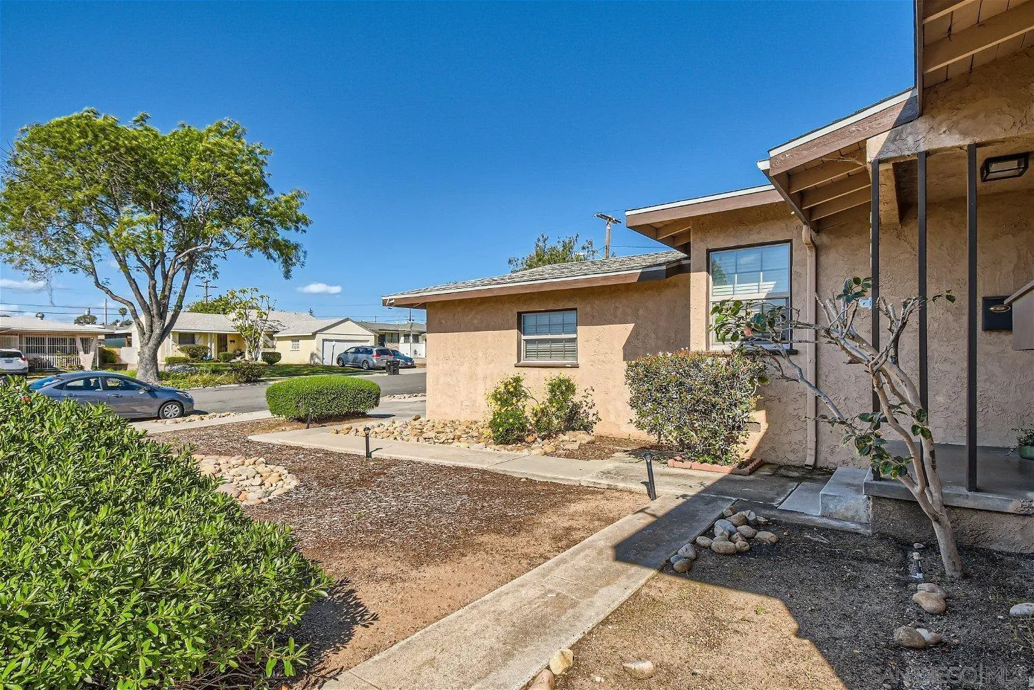 5259 Laurel Street San Diego, CA 92105 - Photo 31 of 32 a view of a house with backyard sitting area and garden