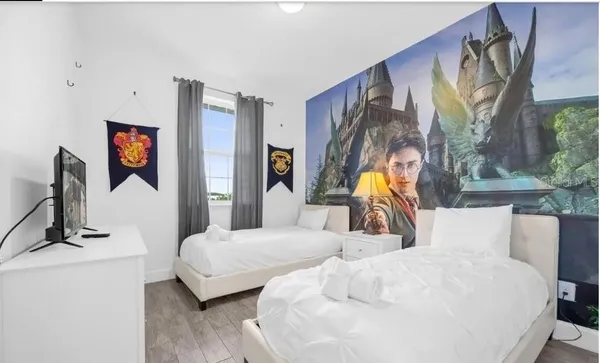 a bedroom with a bed and a painting on the wall