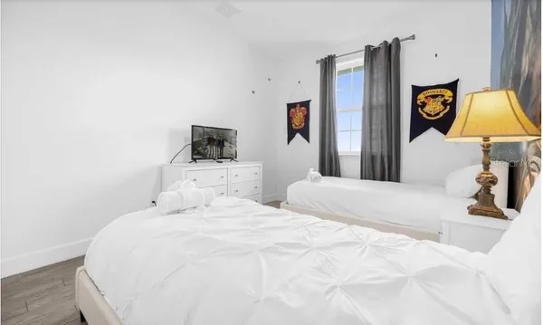 a bedroom with a bed and a flat screen tv