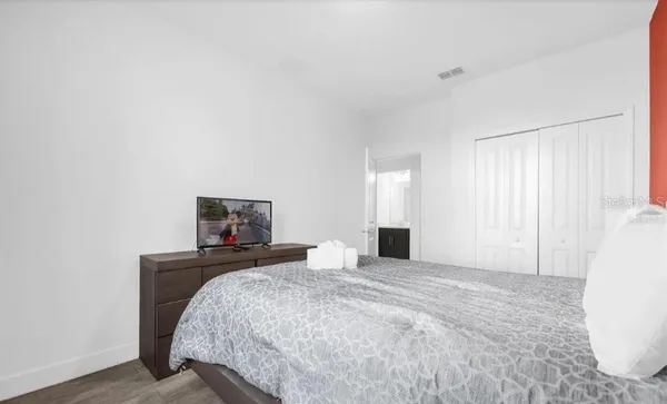 a bedroom with a bed and a couch