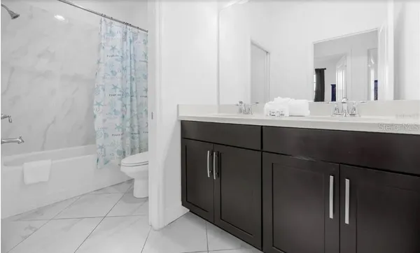 a bathroom with a sink toilet tub and shower