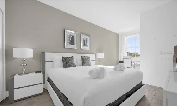 a bedroom with a bed and a lamp