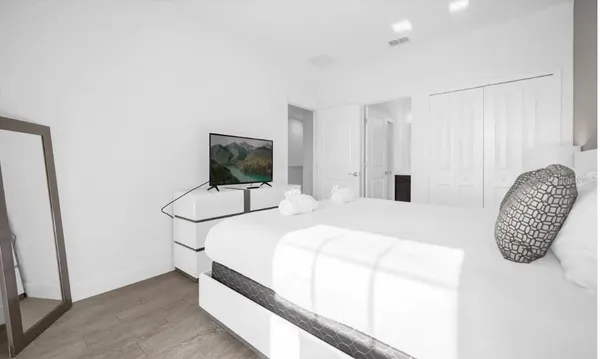 a bedroom with a bed and a television