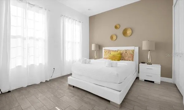 a bedroom with a bed and a window
