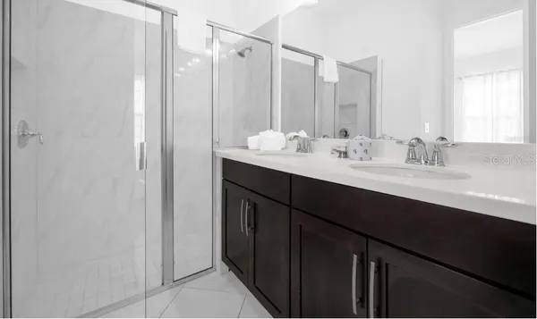 a bathroom with a double vanity sink and mirror