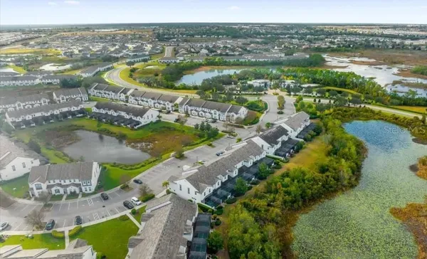 an aerial view of residential houses with outdoor space