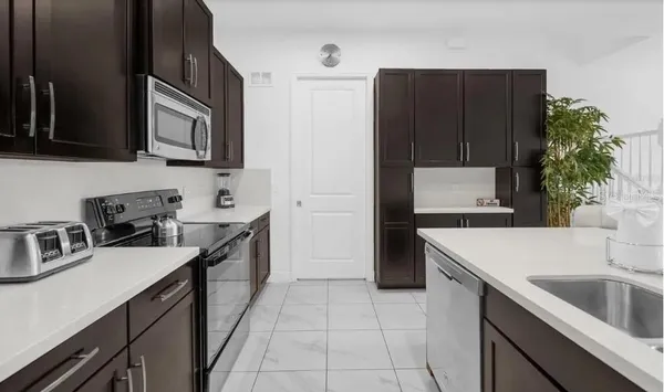 a kitchen with a sink stove and refrigerator