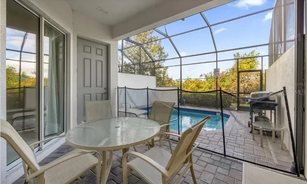 a dining room with furniture and a floor to ceiling window