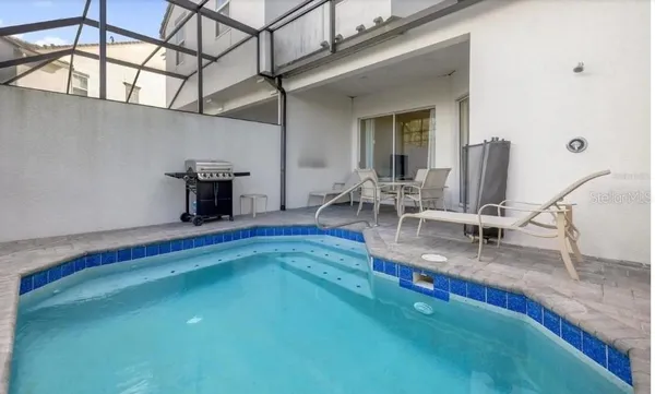 a view of a room with pool table and chairs