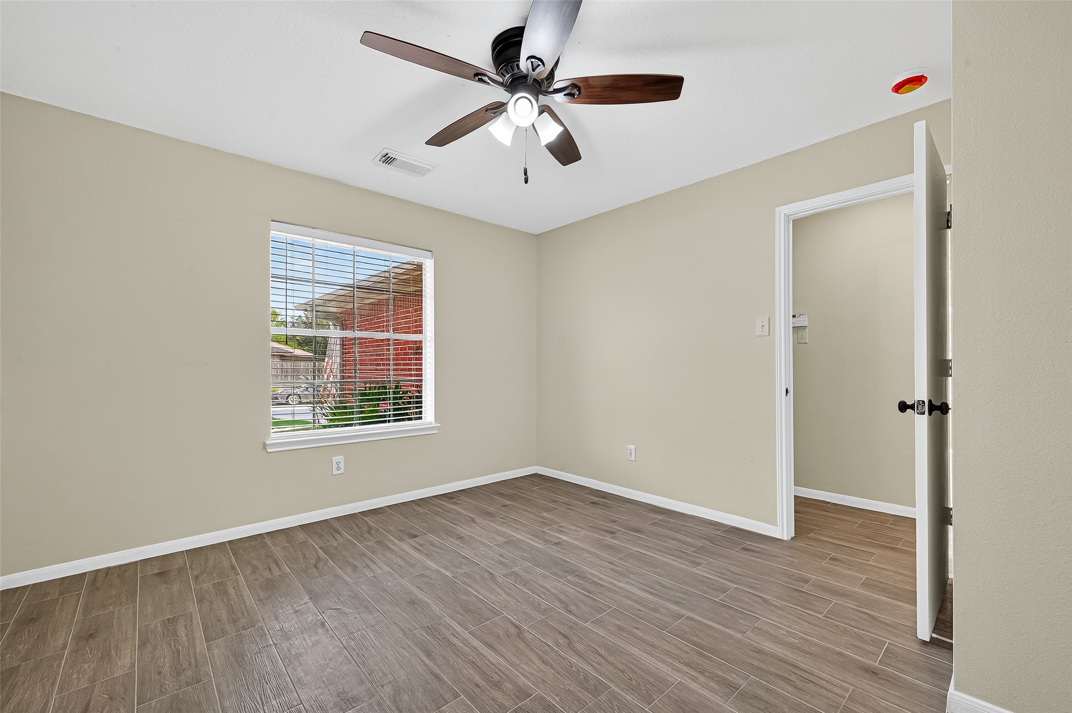 18759 Holly Way Houston, TX 77084 - Photo 11 of 46 wooden floor in an empty room with a window