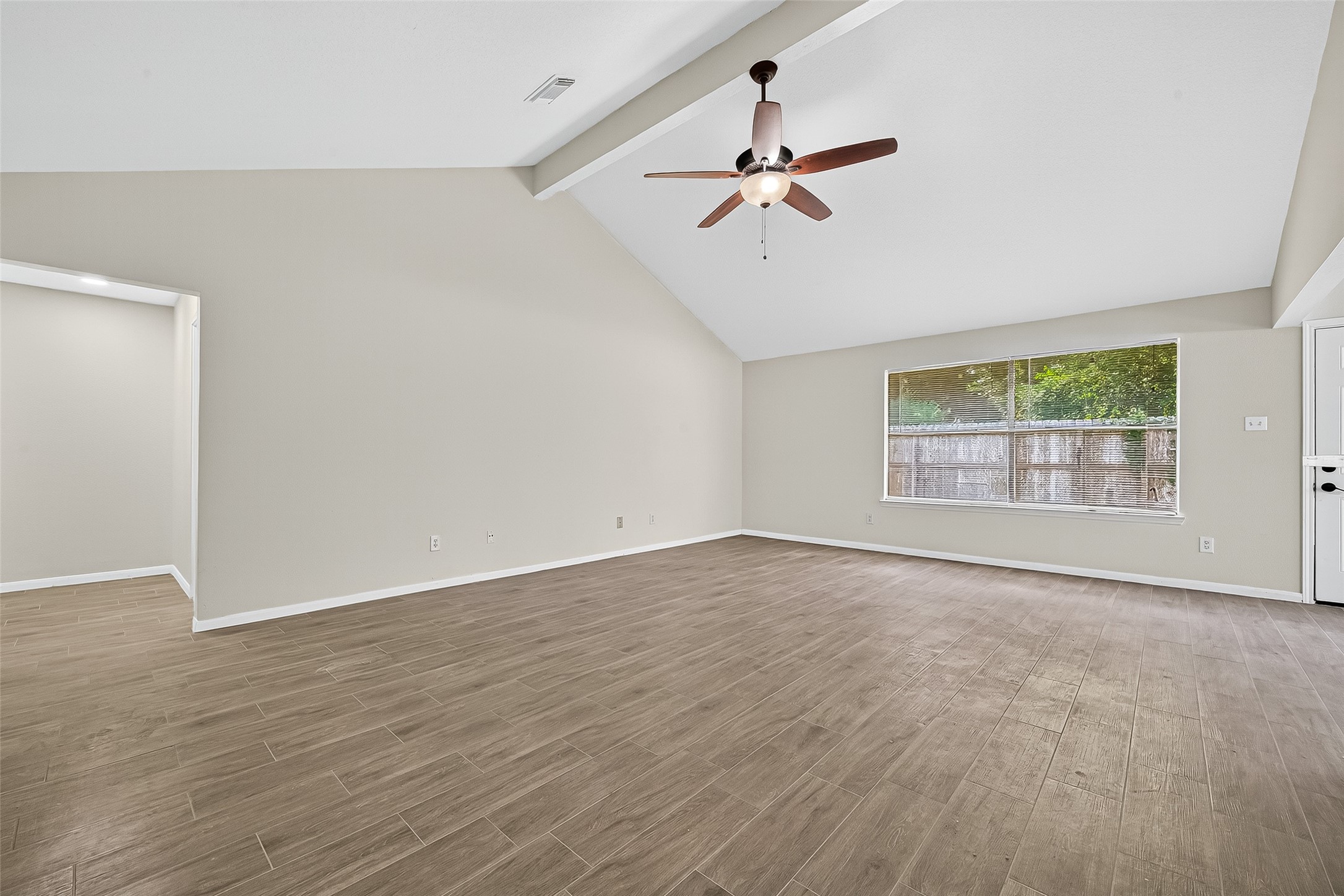18759 Holly Way Houston, TX 77084 - Photo 14 of 46 a view of an empty room with a window and wooden floor