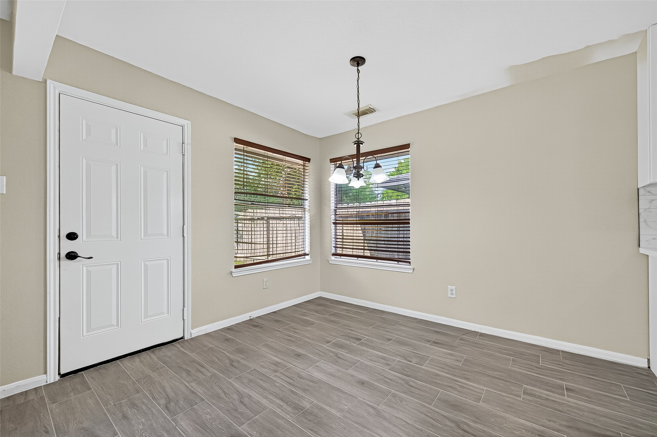 18759 Holly Way Houston, TX 77084 - Photo 19 of 46 a view of an empty room with wooden floor kitchen view and a window