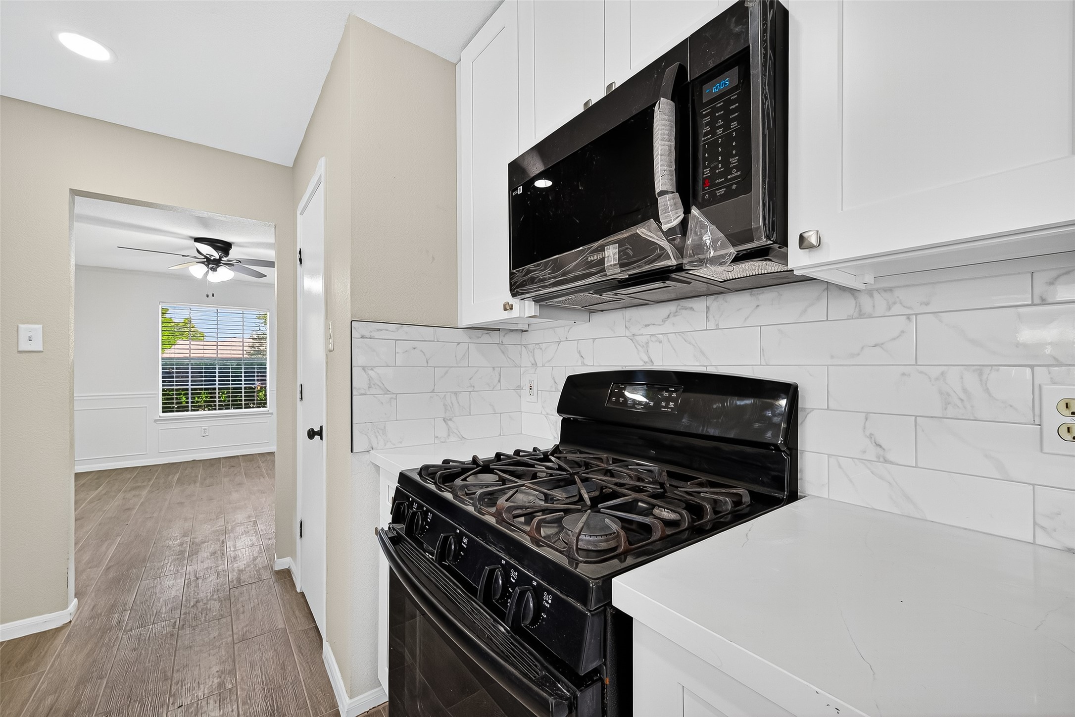 18759 Holly Way Houston, TX 77084 - Photo 25 of 46 a kitchen with a stove and a microwave