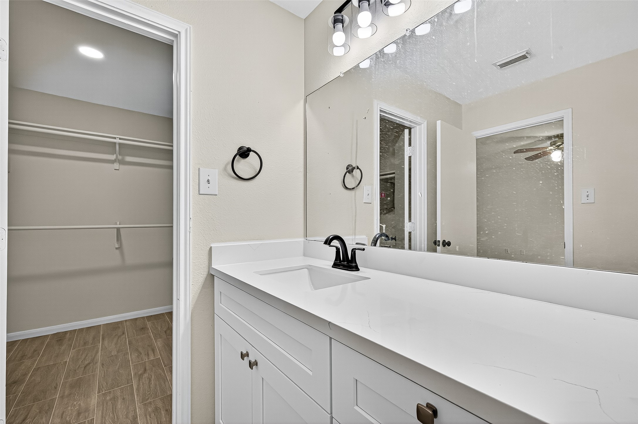 18759 Holly Way Houston, TX 77084 - Photo 35 of 46 a en suite bathroom with a shower sink and mirror