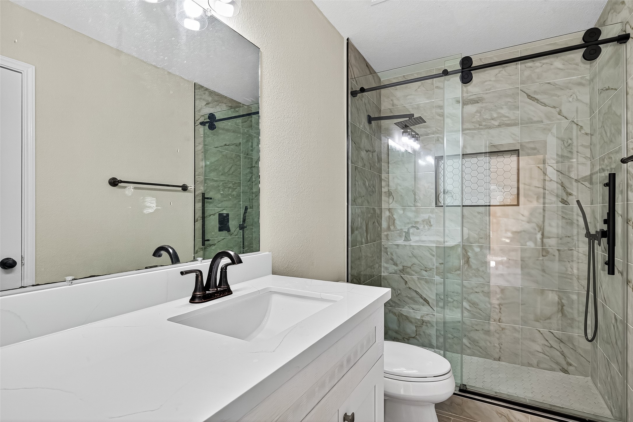 18759 Holly Way Houston, TX 77084 - Photo 40 of 46 a bathroom with a sink toilet a mirror and shower
