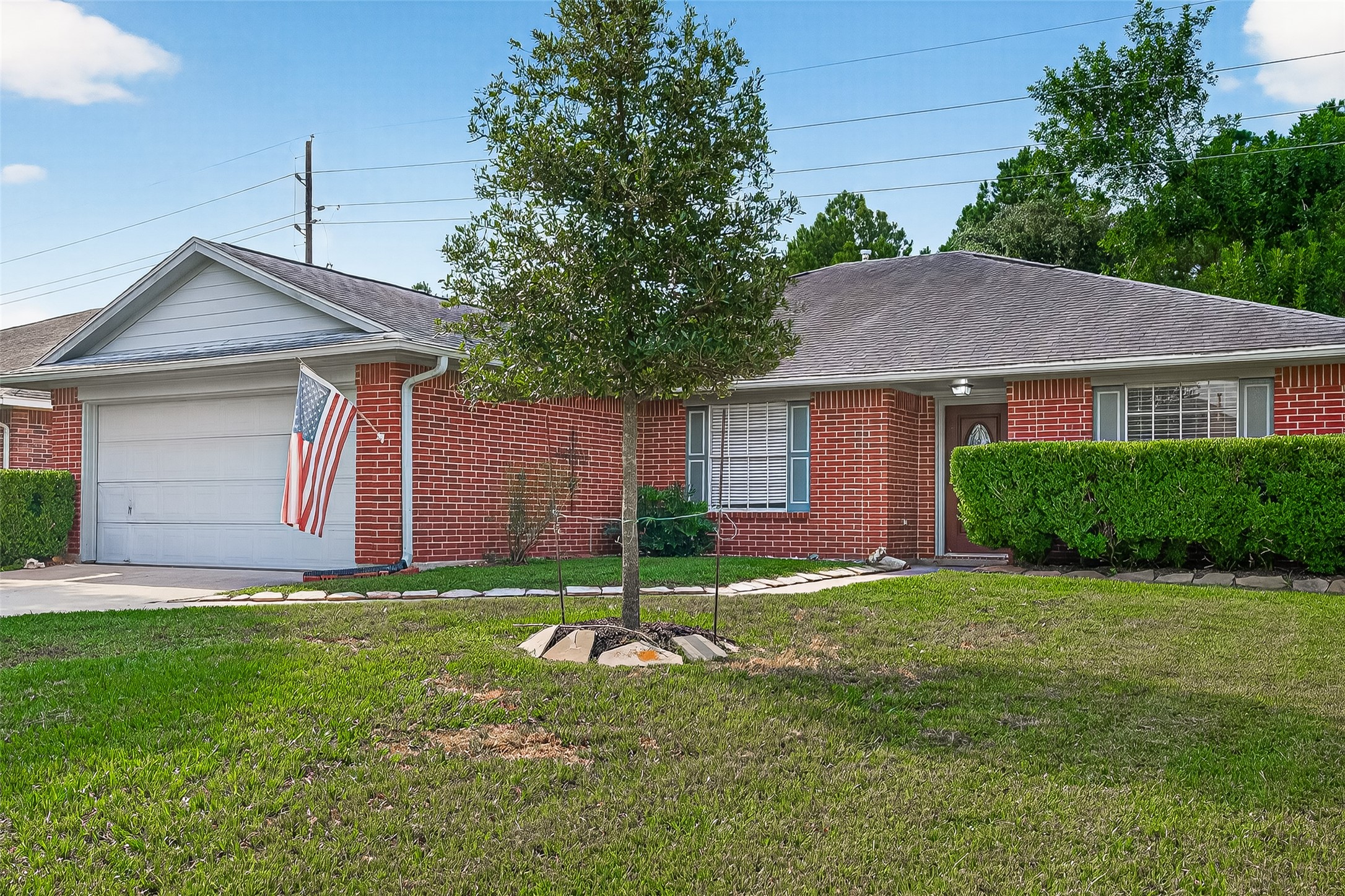 18759 Holly Way Houston, TX 77084 - Photo 4 of 46 a backyard of a house with plants and large tree