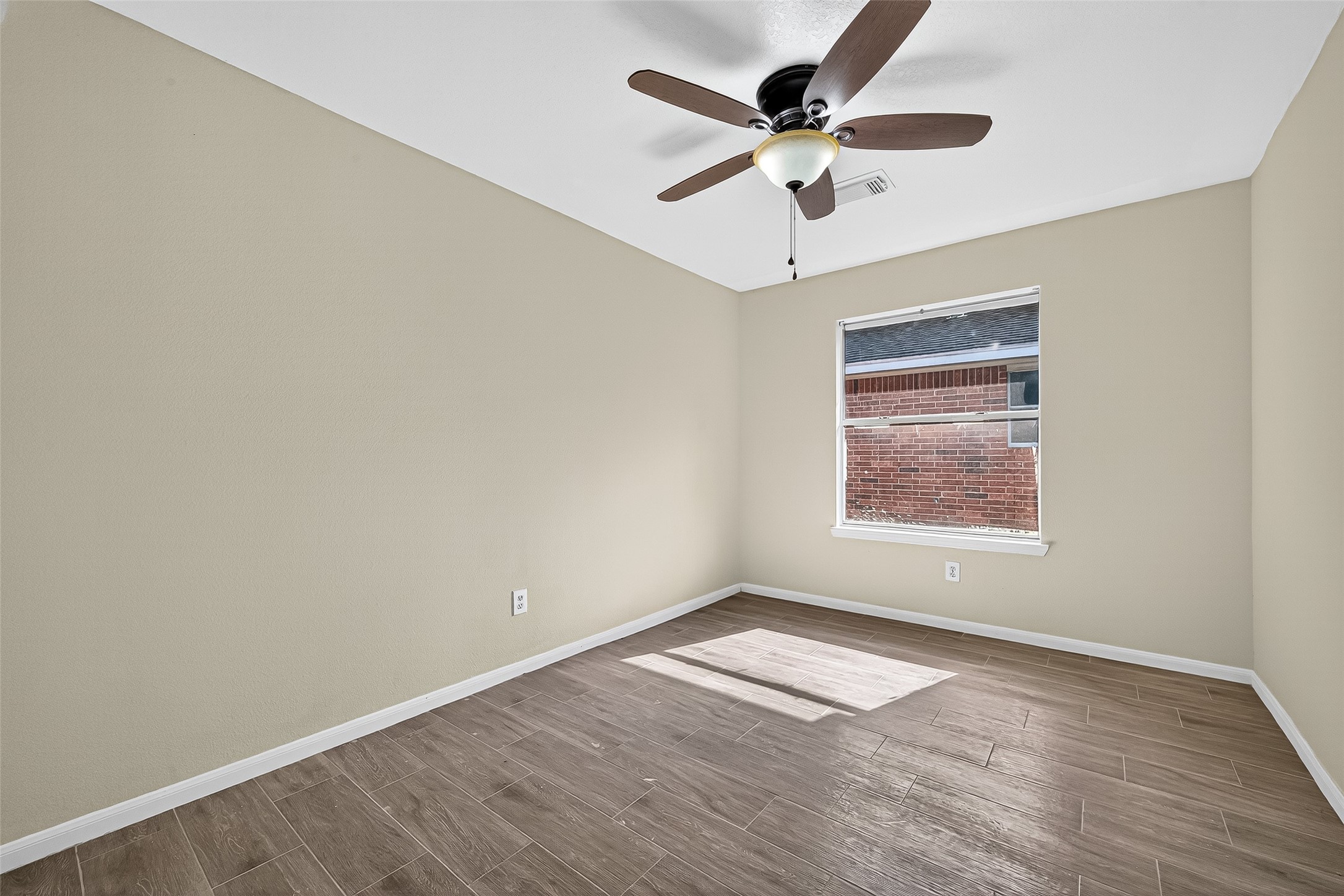18759 Holly Way Houston, TX 77084 - Photo 41 of 46 an empty room with wooden floor and windows