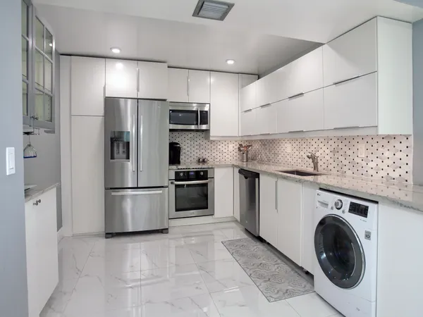 a kitchen with refrigerator a washer and dryer
