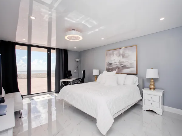 a bedroom with a large bed and a large window