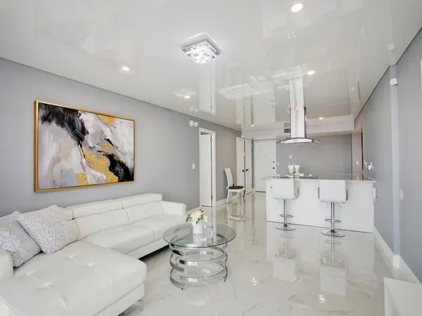 a living room with furniture and a painting