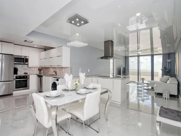 a kitchen with kitchen island a large counter top space appliances and cabinets