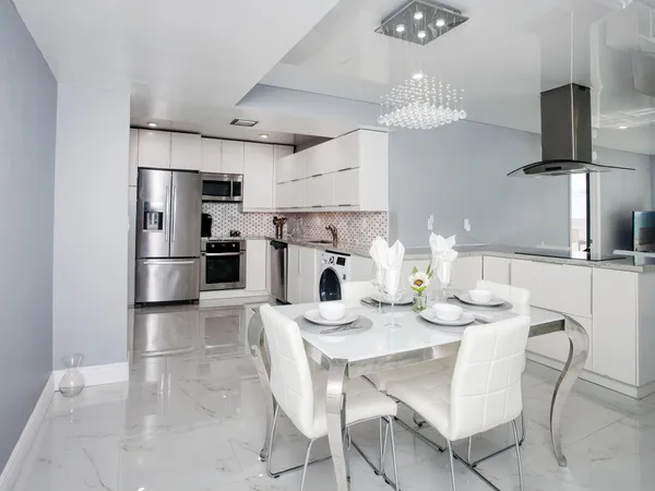 a kitchen with kitchen island a refrigerator and a dining table