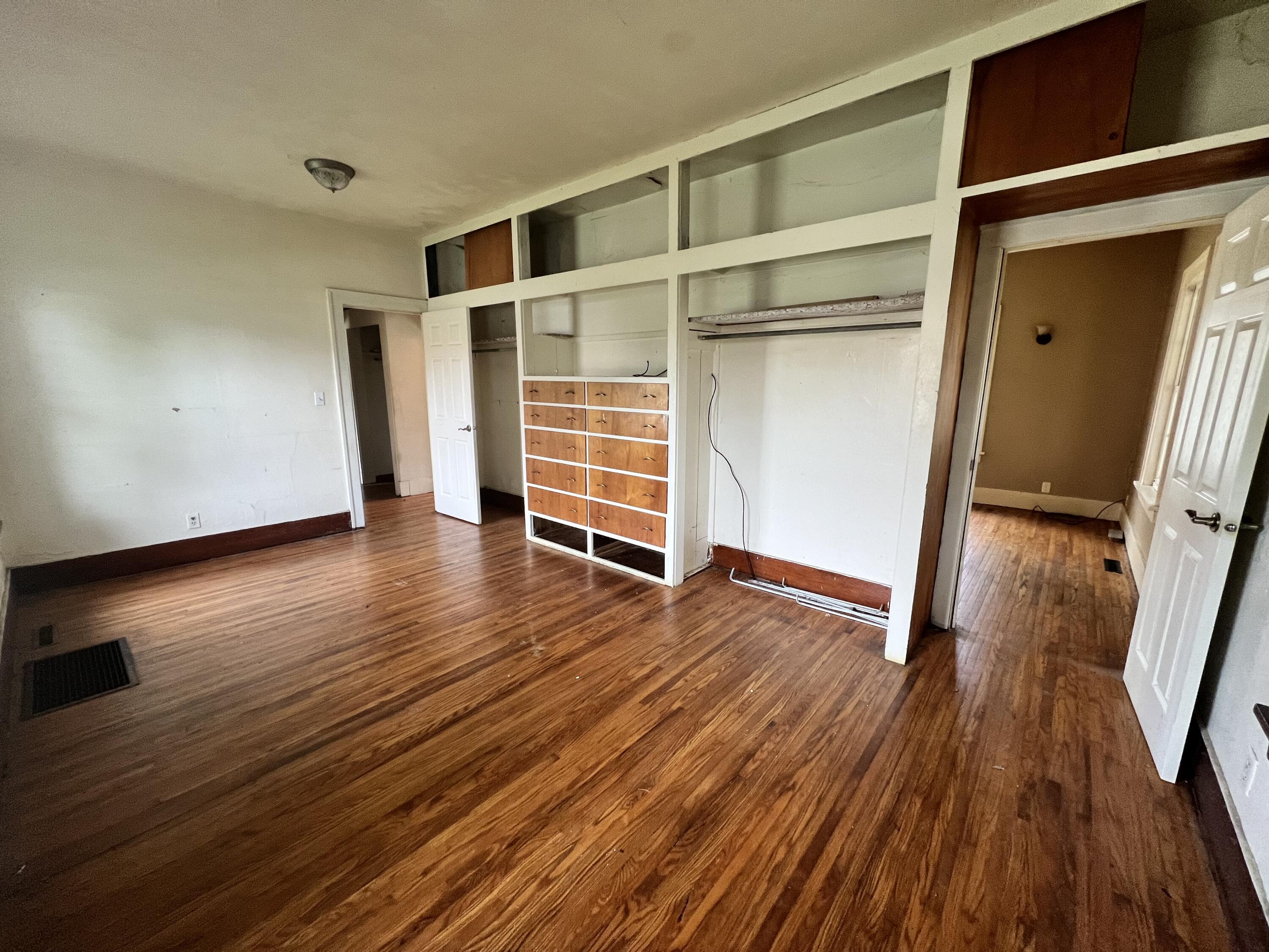 702 East Elm Street Rensselaer, IN 47978 - Photo 14 of 22 a view of an empty room with wooden floor and a window
