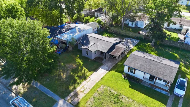 an aerial view of a house with a garden and swimming pool