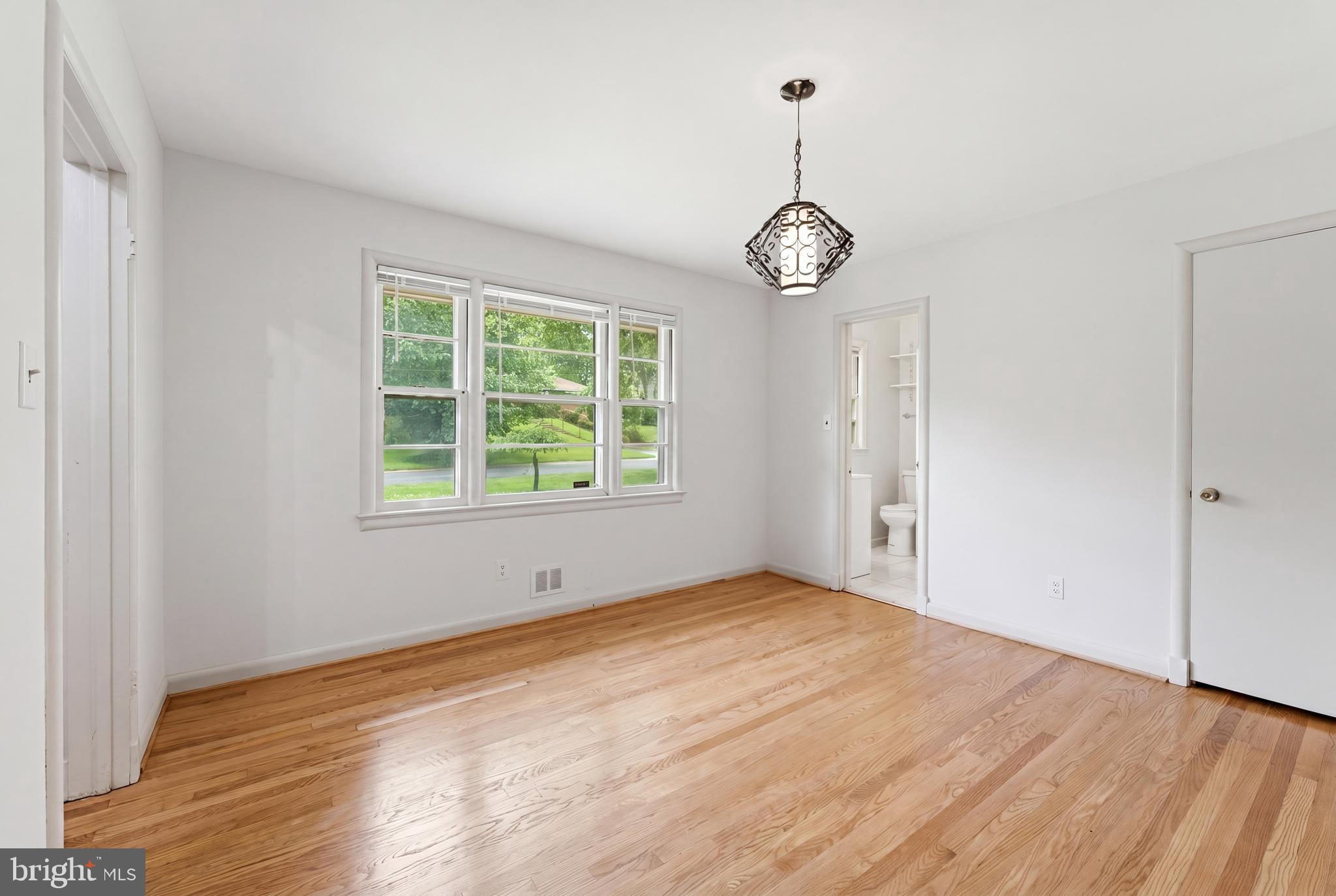 228 Northwest Terrace Silver Spring, MD 20901 - Photo 7 of 70 an empty room with wooden floor and windows