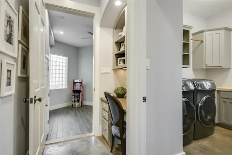 a view of a patio with couches and table and chairs with wooden fence and plants