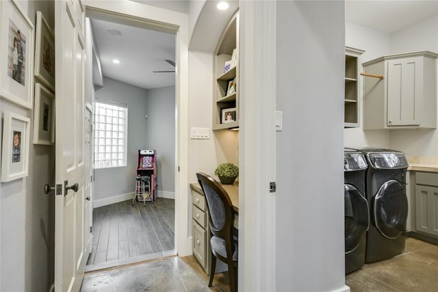 a view of a patio with couches and table and chairs with wooden fence and plants